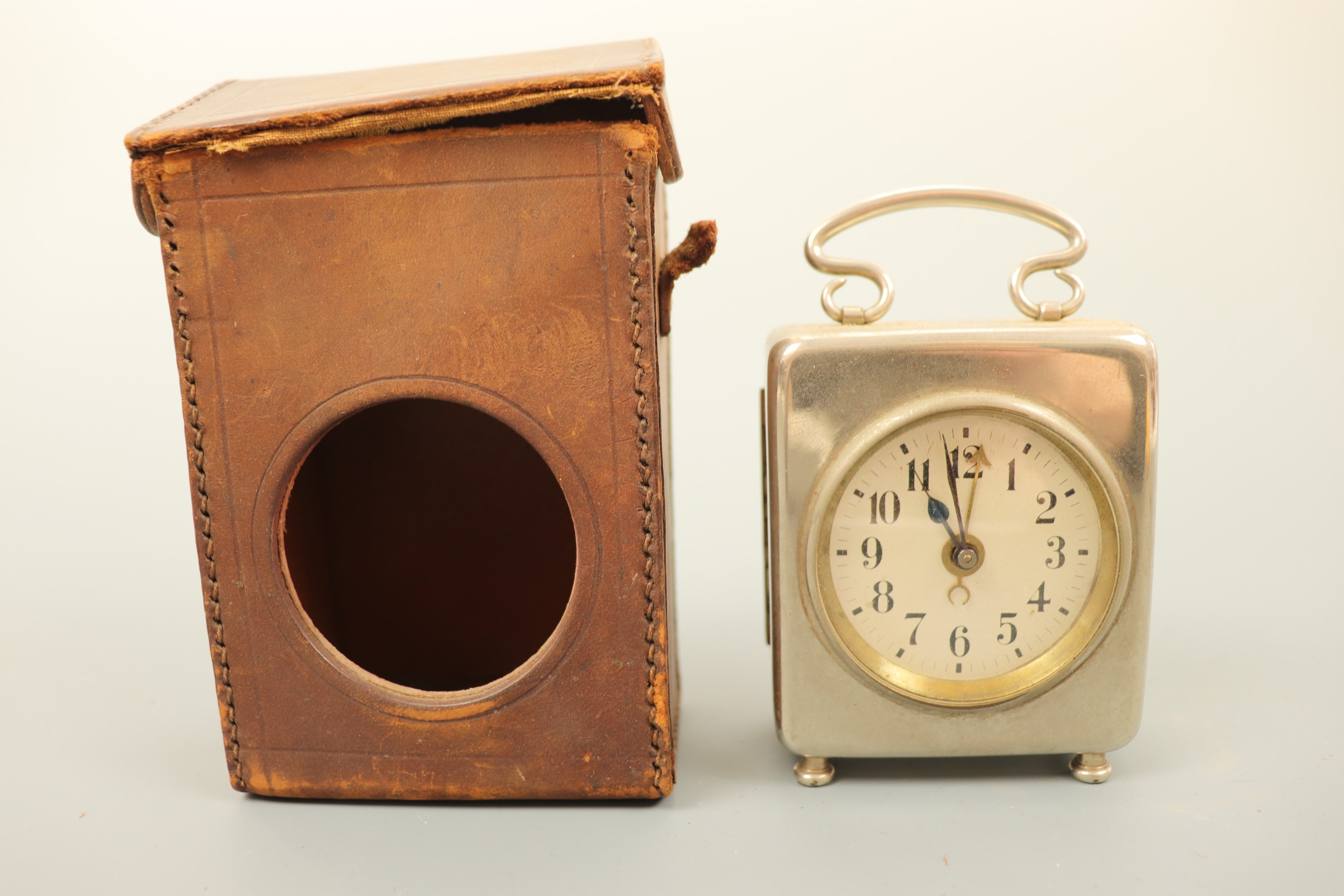 An early 20th Century bedside travel alarm clock, with silvered dial and Arabic numerals, in a - Image 2 of 2