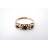 A 9ct gold diamond and sapphire dress ring, set in an alternating arrangement, comprising central