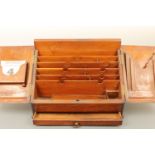 A Victorian oak desk compendium, having a base drawer and a pair of doors, opening to reveal a