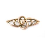 A late 19th / early 20th Century Modernist "rose" yellow metal brooch, on the form of interlocking
