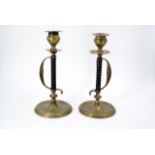 A pair of brass and turned wood candlesticks, their stems modelled as sword hilts, 21 cm