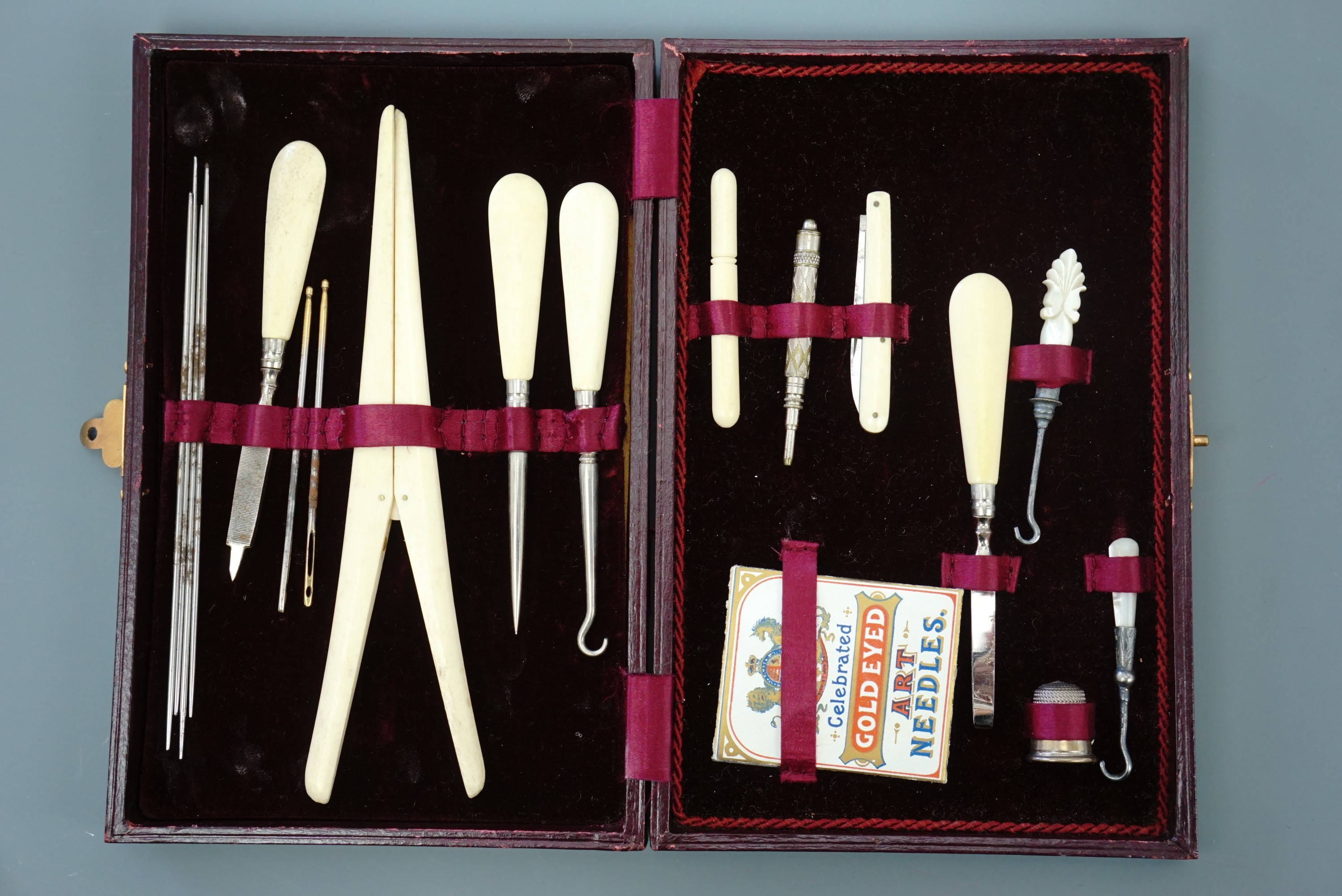 A Victorian lady's bone and polished steel sewing, dressing and manicure set in gilt-tooled claret
