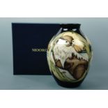 A contemporary Moorcroft limited edition shouldered vase, the decoration depicting otters, signed