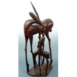 An African carved wooden antelope and young, 65 cm high