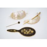 Two carved mother-of-pearl hair ornaments together with a Japanese shakudo ware stick pin and