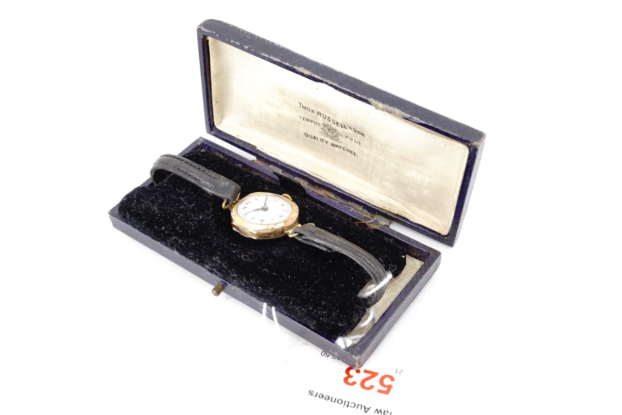 A lady's 9ct gold cased wrist watch, having a Swiss made 15 jewel movement, silvered face and Arabic