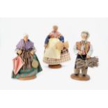 Three earthenware dolls, tallest 18 cm