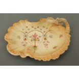 A Crown Devon blush ivory hors d'oeuvres dish, having a Rococo scalloped rim and handle, decorated