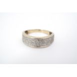 A contemporary diamond and yellow-metal (tested as gold) half hoop eternity ring, the face channel