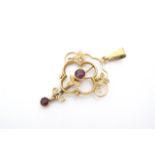 A Belle Epoque yellow metal openwork pendant set with amethyst coloured stones, marked 9 ct, 3 cm,