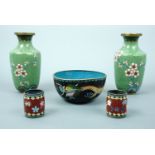 A pair of cloissoné vases, 13 cm high, a cloissoné bowl, 5 cm high, and two small pots