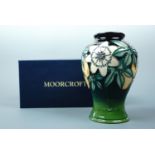 A contemporary Moorcroft shouldered vase, the decoration depicting passion flowers, signed and