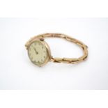 A 1920s lady's 9 ct gold cased wristlet watch, on a rolled gold flexible bracelet strap, (a/f)