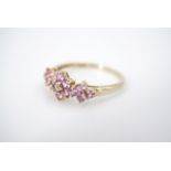 A 9ct gold and pink spinel dress ring, in a triple flower head cluster arrangement, size V, 2.4 g