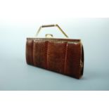 A vintage reptile skin clutch / handbag by Widgate of London, having a "disappearing" handle