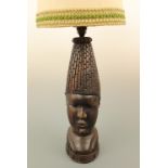 A large African carved hardwood table lamp modelled as a bust, 42 cm to socket