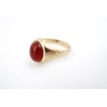 A 9ct gold and carnelian signet ring, the carnelian cabochon sunken set on a tapering shank, with