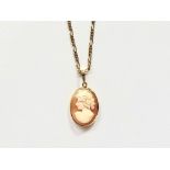 A gilt white metal and shell cameo pendant, approximately 2 cm, on a conforming neck chain