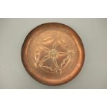 A Keswick School of Industrial Art copper dish, decorated with a rose device, stamped KSIA, 10.5 cm
