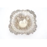 A late Victorian reticulated silver dish, decorated wit C-scrolls, blossom and ribbon-bows, 13 cm,