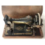 An early 20th Century singer hand-cranked sewing machine, serial Y9127484, (a/f)