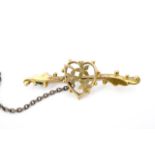 A Victorian yellow metal bar brooch, faced with a heart-and-flowers device, cased, 4.5 cm, 2.0 g