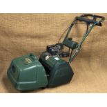 An Atco Balmoral 14SE electric start, self propelled petrol lawn mower with scarifier attachment