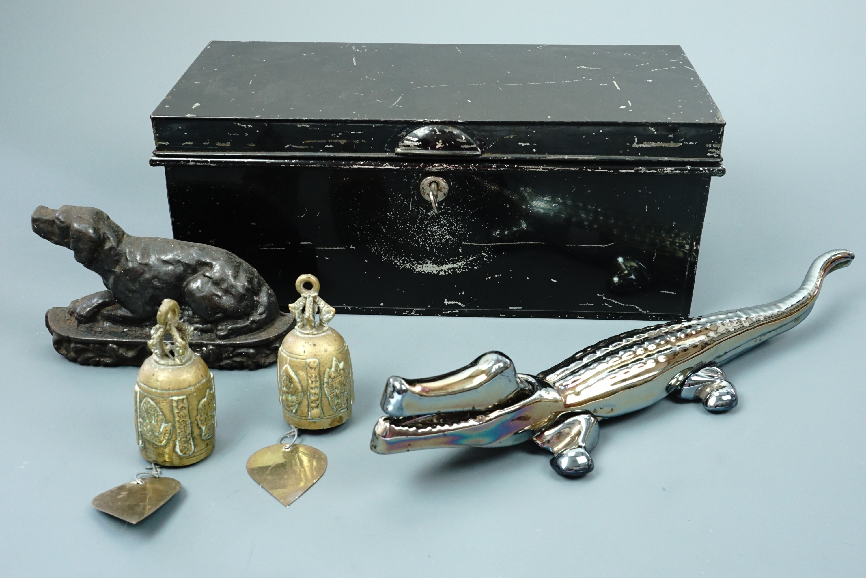 A vintage black Japanned deed box together with a enamelled novelty nut cracker in the form of a
