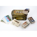 A Rington's Royal Casket 1925 silver jubilee commemorative tinplate box containing cigarette cards