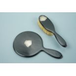 An early George V silver mounted ebony mirror and brush set, having foliate engraved decoration, H F