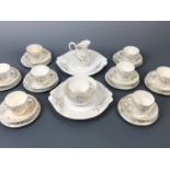 A late Victorian tea set for eight, comprising nine tea cups, eight saucers, eight cake plates,