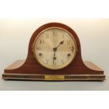 A 1930s mahogany cased "Napoleon hat" mantle clock with silvered face and Arabic numerals, with 1936