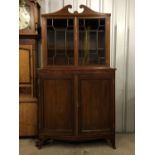 A Sheraton revival string-inlaid and cross-banded mahogany cabinet, having and astragal-glazed upper