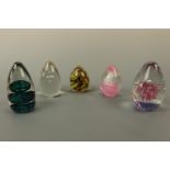 Five oviform glass paperweights