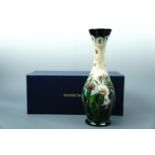 A contemporary Moorcroft "Thistledown" pattern limited edition elongated baluster vase, with
