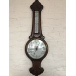 A late 19th / early 20th Century carved oak banjo barometer, 85 cm