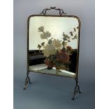 A late Victorian / early 20th Century brass fire screen with floral-enamelled mirror insert