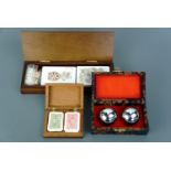 A modern unused Reader's Digest wooden games box containing playing cards and dice, together with