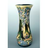 A contemporary Moorcroft vase, of elongated baluster form with everted rim, decorated in an