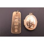 A 9ct gold locket and a 9ct gold pendant, the former having engraved foliate decoration to the face,
