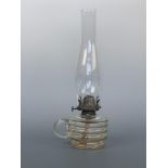 An antique glass finger oil lamp