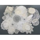 Antique and vintage tea linens, including beaded preserve jar covers, doilies, and decorative mats