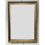 A contemporary gilt framed wall mirror, of antique style, having foliate decoration, can be