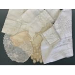 A quantity of antique tea linens, including whitework tea tray liners, one having a scalloped edge