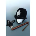 A Cumbria Constabulary "Custodian" helmet, together with a truncheon and Police badges