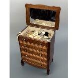 A vintage musical jewellery chest, containing a quantity of costume jewellery brooches and earrings