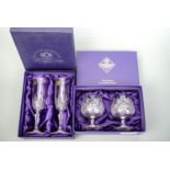 A pair of boxed Edinburgh Crystal brandy glasses, together a pair of boxed wine glasses, (free of