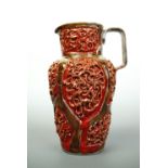 An Italian earthenware jug, of shouldered form, decorated with incised strapwork surrounding a