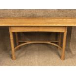 An Ercol Saville pattern elm side table, having a shaped plank top, two drawers and four spreading