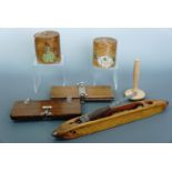 Two 1930s painted wooden string boxes, two tie presses, a darning mushroom and loom shuttle